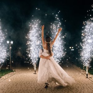 Beautiful,Happy,Young,Wedding,Couple,Dancing,Outdoor,Between,Fireworks